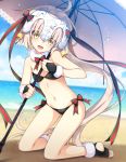  1girl adapted_costume ahoge alternate_costume ass bangs beach bell bikini black_bikini blonde_hair blurry blush bow breasts cleavage depth_of_field eyebrows_visible_through_hair fate/grand_order fate_(series) green_bow green_ribbon headpiece holding holding_umbrella jeanne_alter jeanne_alter_(santa_lily)_(fate) kneeling long_hair looking_at_viewer navel ocean open_mouth outdoors red_bow red_ribbon ribbon ruler_(fate/apocrypha) saipaco small_breasts smile solo striped striped_bow striped_ribbon swimsuit teeth thighs umbrella very_long_hair yellow_eyes 