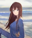  1girl 556 absurdres bangs blue_shirt breasts brown_eyes brown_hair closed_mouth collarbone erect_nipples from_side highres long_hair long_sleeves looking_at_viewer medium_breasts original outdoors pink_lips seaside shirt solo standing upper_body water 