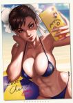  1girl abs absurdres artist_name bangs bare_shoulders beach bikini blue_bikini blue_sky breasts brown_eyes brown_hair bun_cover cameo cellphone cellphone_charm character_name chun-li cleavage clouds cloudy_sky collarbone crayon_shin-chan dandon_fuga day double_bun earrings erect_nipples eyelashes eyeliner eyeshadow fingernails glint groin hand_on_own_cheek hand_on_own_face hands_up highres holding holding_cellphone holding_phone jewelry large_breasts leaning_to_the_side lens_flare light_smile lips lipstick_mark long_fingernails makeup mascara midriff morgana_(persona_5) muscle navel nose ocean one-piece_tan outdoors patreon_reward persona persona_5 phone pink_lips self_shot shin-chan short_hair side-tie_bikini sitting sky smartphone stomach strap_gap street_fighter string_bikini sweat swimsuit taking_picture tan tanline toned water 