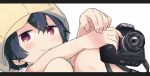  1girl :3 black_hair blush cabbie_hat camera close-up closed_mouth denki-gai_no_hon&#039;ya-san fingernails hair_between_eyes hat holding holding_camera jitome kameko_(denki-gai) letterboxed looking_at_viewer mizu_asato pink_eyes shirt short_hair short_sleeves simple_background sitting smile solo white_background yellow_hat 