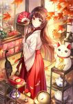  1girl artist_name bangs black_cat black_hair blush broom brown_eyes cat closed_mouth day eyebrows_visible_through_hair fan folding_fan from_side hakama holding holding_broom indoors japanese_clothes lantern leaf light_smile long_hair long_skirt long_sleeves looking_at_viewer looking_back maneki-neko maple_leaf miko original pierorabu pleated_skirt red_skirt ribbon-trimmed_sleeves ribbon_trim shop skirt sliding_doors smile solo standing tatami watermark wide_sleeves 