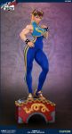  1girl alternate_costume biceps bracelet capcom chun-li copyright_name double_bun figure full_body hair_ribbon highres jewelry looking_at_viewer muscle muscular_female photo ribbon shoes smile sneakers solo street_fighter street_fighter_zero_(series) studded_bracelet toned 