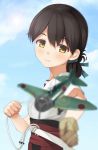  1girl aircraft airplane black_hair brown_eyes brown_hair clouds cloudy_sky folded_ponytail foreshortening gloves hakama highres imachireki japanese_clothes kantai_collection kasuga_maru_(kantai_collection) lens_flare looking_at_viewer partly_fingerless_gloves red_hakama short_hair short_sleeves sky smile solo yugake 