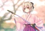  1girl ahoge bangs black_bow blonde_hair blurry blush bow closed_mouth depth_of_field eyebrows_visible_through_hair fate_(series) hair_between_eyes hair_bow hakama half_updo japanese_clothes katana kimono koha-ace looking_at_viewer outdoors pink_kimono pleated_skirt purple_skirt sakura_saber sheath short_hair skirt solo sword ueno_tomo upper_body weapon wide_sleeves yellow_eyes 