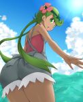  1girl ass dark_skin flower from_behind green_eyes green_hair hair_flower hair_ornament kuro_(be_ok) long_hair looking_at_viewer looking_back mallow_(pokemon) ocean open_mouth pokemon pokemon_(game) pokemon_sm solo twintails 