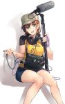  1girl :d aqua_eyes blue_shorts breasts brown_hair cable clothes_writing flat_cap hat headphones headphones_around_neck holding looking_at_viewer medium_breasts microphone microphone_stand open_mouth original raised_hands shirt short_hair short_shorts short_sleeves shorts sitting smile solo sony white_background yellow_shirt yomo_(majidon) 