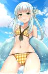  1girl arms_behind_back bangs bikini blue_sky blush breasts checkered checkered_bikini closed_mouth clouds commentary_request day eyebrows_visible_through_hair front-tie_top gluteal_fold green_eyes highres holding_innertube long_hair looking_at_viewer mishin_(mbmnk) navel original outdoors sidelocks silver_hair sky small_breasts solo standing swimsuit transparent water wet yellow_bikini 