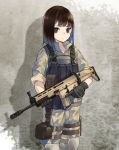  1girl black_gloves brown_eyes brown_hair camouflage camouflage_jacket camouflage_pants closed_mouth collarbone cowboy_shot fn_scar gloves gun highres holding holding_gun holding_weapon holster kevlar_vest knee_pads long_sleeves looking_at_viewer military military_uniform nuqura original pants shadow short_hair sleeves_rolled_up solo standing thigh_holster uniform wall weapon woodland_pattern 