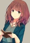  1girl blush book brown_hair collarbone eyebrows_visible_through_hair green_eyes highres holding holding_book jewelry looking_at_viewer medium_hair mole mole_under_eye necklace open_book original smile solo sutorora upper_body 