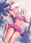  1girl :d bangs bare_legs barefoot beach bikini bikini_skirt blush breasts chloe_von_einzbern collarbone commentary_request dark_skin day eyebrows_visible_through_hair fate/kaleid_liner_prisma_illya fate_(series) frilled_bikini frills from_above hair_between_eyes haribote_(tarao) long_hair looking_at_viewer lying navel ocean on_back open_mouth outdoors pink_bikini sand silver_hair small_breasts smile solo swimsuit water wet yellow_eyes 