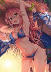  1girl armpits arms_up bangs bikini blue_bikini bracelet breasts brown_eyes contrapposto cowboy_shot evening eyebrows_visible_through_hair fate/grand_order fate_(series) hat highres hips innertube jewelry kawai long_hair looking_at_viewer medium_breasts navel open_mouth outdoors pink_hair smile solo straw_hat sun_hat swimsuit tamamo_(fate)_(all) tamamo_no_mae_(swimsuit_lancer)_(fate) thighs wavy_hair 