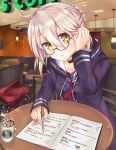  1girl adjusting_hair ahoge artoria_pendragon_(all) blonde_hair blush braid choker coffee_mug fate/grand_order fate_(series) french_braid glasses heroine_x heroine_x_(alter) highres hiragana hood hoodie looking_at_viewer mechanical_pencil moai21 notebook open_mouth paper pencil plaid school_uniform semi-rimless_glasses serafuku solo table under-rim_glasses yellow_eyes 