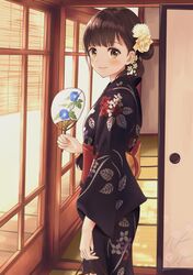  1girl black_kimono blinds blush brown_hair day fan floral_print flower folded_ponytail from_side hair_flower hair_ornament highres indoors japanese_clothes kimono looking_at_viewer obi original paper_fan sash sliding_doors smile solo tatami uchiwa yellow_eyes yukata yukimaru217 