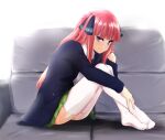  1girl aoyama_kiiro ass bangs black_cardigan black_ribbon blue_eyes blunt_bangs blush butterfly_hair_ornament cardigan couch feet go-toubun_no_hanayome hair_ornament hime_cut hugging_own_legs knees_to_chest knees_up long_hair looking_at_viewer nakano_nino open_cardigan open_clothes pink_hair ribbon shirt sitting smile soles thick_thighs thigh-highs thighs twintails white_legwear white_shirt 
