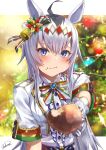  1girl :/ absurdres ahoge animal_ears bangs bell blue_eyes blurry blurry_background blush breasts brooch buttons center_frills chakuma_(yiyh1468) chicken_leg christmas_ornaments christmas_tree closed_mouth commentary_request dot_nose dress eating food food_in_mouth food_on_face frills gem gloves gold_trim hair_ornament highres holding holding_food horse_ears horse_girl jewelry jingle_bell leaf letterboxed lips looking_at_viewer medium_breasts oguri_cap_(umamusume) pointing pointing_at_viewer short_sleeves signature silver_hair solo standing tree umamusume upper_body white_dress white_gloves 