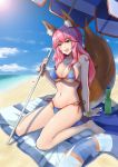  1girl absurdres animal_ears beach bikini blue_bikini blush bmou breasts cleavage day fang fate/extra fate/grand_order fate_(series) fox_ears fox_tail groin highres innertube large_breasts long_hair looking_at_viewer navel ocean open_mouth outdoors parasol pink_hair sitting solo swimsuit tail tamamo_(fate)_(all) tamamo_no_mae_(swimsuit_lancer)_(fate) umbrella wariza yellow_eyes 