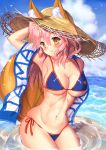  1girl animal_ears bikini blue_bikini blush breasts cleavage closed_mouth cowboy_shot day ears_through_headwear fate/grand_order fate_(series) fox_ears fox_tail hair_between_eyes highres large_breasts long_hair looking_at_viewer mogupuchi navel ocean pink_hair smile solo stomach swimsuit tail tamamo_(fate)_(all) tamamo_no_mae_(swimsuit_lancer)_(fate) wading yellow_eyes 