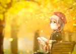  1girl autumn_leaves bangs bench beret black-framed_eyewear blurry bokeh book braid closed_mouth depth_of_field eyebrows_visible_through_hair from_side glasses green_eyes grey_hair hat hiten_(hitenkei) holding holding_book leaf open_book original sitting solo sweater 
