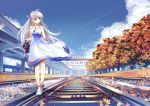  1girl ahoge autumn autumn_leaves bird bow braid china_railway_girl clouds day dress erich full_body hair_bow halterneck long_hair looking_back orange_eyes original outdoors railroad_tracks silver_hair sky solo train_station very_long_hair walking white_footwear 