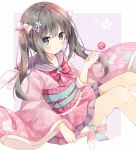  1girl :o bangs blush bow bowtie brown_hair checkered commentary_request eyebrows_visible_through_hair floral_print flower frilled_kimono frills green_eyes hair_bobbles hair_bow hair_flower hair_ornament hand_up highres holding holding_lollipop hoshi_(snacherubi) japanese_clothes kimono long_hair long_sleeves looking_at_viewer obi original parted_lips pink_bow pink_kimono pinwheel print_kimono purple_sailor_collar red_neckwear sailor_collar sash short_kimono sidelocks simple_background sitting solo twintails white_wings wide_sleeves wings 