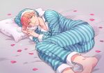  1boy ass barefoot fate/grand_order fate_(series) fujinari_takumi green_eyes hat lying male_focus nightcap on_side pajamas petals pillow pink_hair romani_akiman smile solo striped 