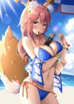  1girl animal_ears beach beach_towel between_breasts bikini blue_bikini blush bracelet breast_hold breasts cleavage contrapposto cowboy_shot day fate/grand_order fate_(series) fox_ears fox_tail highres jewelry large_breasts long_hair looking_at_viewer masuishi_kinoto mouth_hold outdoors pink_hair ribbon_in_mouth side-tie_bikini solo sunlight swimsuit tail tamamo_(fate)_(all) tamamo_no_mae_(swimsuit_lancer)_(fate) towel wet wet_hair yellow_eyes 