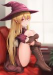  1girl bangs blonde_hair blurry blurry_background blush boots brown_footwear brown_gloves cangmi couch cross-laced_footwear dress elf eyebrows_visible_through_hair from_side gloves hat indoors knees_up leg_hug long_hair looking_at_viewer original parted_lips pointy_ears red_eyes room short_sleeves sitting solo window witch_hat 