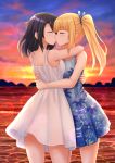  2girls beach black_hair blonde_hair blue_dress blue_ribbon closed_eyes dress eyebrows_visible_through_hair floral_print highres hug kazenokaze kiss long_hair multiple_girls original ribbon sunset twintails white_dress yuri 