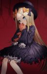  1girl abigail_williams_(fate/grand_order) black_dress blonde_hair blue_eyes bow dress fate/grand_order fate_(series) gambe hair_bow hands_in_sleeves hat highres long_hair long_sleeves looking_at_viewer sleeves_past_wrists solo stuffed_animal stuffed_toy teddy_bear 