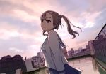  1girl :/ brown_eyes brown_hair clouds cloudy_sky day dutch_angle fence from_side hair_ornament hairclip long_hair morifumi original outdoors revision rooftop school_uniform serafuku shirt skirt sky solo twintails 