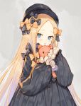  1girl abigail_williams_(fate/grand_order) bangs black_bow black_dress black_hat blonde_hair blue_eyes blush bow dress fate/grand_order fate_(series) grey_background hair_bow hands_in_sleeves hat holding holding_stuffed_animal long_hair long_sleeves orange_bow parted_bangs parted_lips rosette_(yankaixuan) solo stuffed_animal stuffed_toy teddy_bear upper_body very_long_hair 