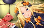  1girl :o abigail_williams_(fate/grand_order) bangs black_bow black_dress black_hat blonde_hair blue_eyes blush bow commentary_request dress fate/grand_order fate_(series) hair_bow hat hat_removed headwear_removed highres kana616 long_hair long_sleeves looking_at_viewer lying on_back orange_bow parted_bangs parted_lips polka_dot polka_dot_bow red_bow sleeves_past_wrists solo stuffed_animal stuffed_toy teddy_bear upper_teeth 
