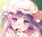  1girl bangs blue_ribbon blunt_bangs blush bun_cover collared_dress commentary_request cookie crescent crescent_moon_pin dress ear eating fingernails food gradient gradient_background green_background hat hat_ribbon holding holding_food jpeg_artifacts long_hair long_sleeves looking_at_viewer mob_cap nose_blush patchouli_knowledge pink_dress pink_hat purple_hair red_ribbon ribbon solo thick_eyebrows touhou upper_body vanilla_(miotanntann) violet_eyes yellow_background 