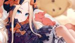  1girl abigail_williams_(fate/grand_order) bangs black_bow black_dress black_hat blonde_hair bloomers blue_eyes blurry blurry_background bow butterfly commentary_request depth_of_field dress fate/grand_order fate_(series) forehead hair_bow hat long_sleeves looking_at_viewer omaru_gyuunyuu orange_bow parted_bangs parted_lips polka_dot polka_dot_bow sitting sleeves_past_wrists solo stuffed_animal stuffed_toy teddy_bear underwear white_bloomers 