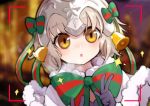 1girl bangs bell black_gloves blurry blurry_background blush bow brown_eyes capelet chestnut_mouth christmas commentary_request depth_of_field double_v eyebrows_visible_through_hair fate/grand_order fate_(series) fur-trimmed_capelet gloves green_bow green_ribbon headpiece highres jeanne_d&#039;arc_(fate)_(all) jeanne_d&#039;arc_alter_santa_lily kiyomasa_ren leaning_to_the_side looking_at_viewer parted_lips ribbon solo sparkle striped striped_bow striped_ribbon v viewfinder white_capelet 