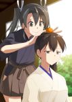  2girls black_hair brown_eyes commentary_request cowboy_shot food food_on_head fruit fruit_on_head grey_eyes grey_hair highres hip_vent kaga_(kantai_collection) kantai_collection long_hair mandarin_orange masukuza_j multiple_girls object_on_head remodel_(kantai_collection) side_ponytail twintails upper_body zuikaku_(kantai_collection) 