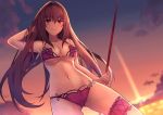  1girl bikini blush breasts cleavage commentary_request fate/grand_order fate_(series) flower gae_bolg hair_flower hair_ornament hibiscus kurifuto large_breasts leg_garter long_hair looking_at_viewer navel pink_bikini purple_bikini purple_hair red_eyes scathach_(fate/grand_order) scathach_(swimsuit_assassin)_(fate) smile solo swimsuit thigh_strap twilight 