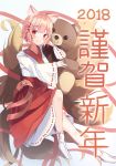  1girl 2018 animal_ears bangs blush closed_mouth commentary_request eyebrows_visible_through_hair fox_ears fox_girl fox_tail hakama happy_new_year highres japanese_clothes kimono kyuubi long_sleeves looking_at_viewer multiple_tails nengajou new_year no_shoes object_hug original pink_hair red_eyes red_hakama ribbon-trimmed_sleeves ribbon_trim seero short_hair sitting slit_pupils smile solo stuffed_animal stuffed_toy tabi tail teddy_bear translated whisker_markings white_kimono white_legwear wide_sleeves 