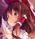  1girl bangs bow brown_eyes brown_hair closed_mouth commentary commission english_commentary eyebrows_visible_through_hair face hair_bow hair_tubes hakurei_reimu hand_up hitsukuya holding long_hair ofuda red_bow smile solo touhou 