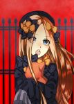  1girl abigail_williams_(fate/grand_order) bangs black_bow black_dress black_hat blonde_hair blue_eyes blush bow chestnut_mouth commentary_request dress eyebrows_visible_through_hair eyes_visible_through_hair fate/grand_order fate_(series) fence forehead hair_bow hat head_tilt kokuchi_45 long_hair long_sleeves looking_at_viewer object_hug open_mouth orange_bow parted_bangs polka_dot polka_dot_bow red_background sleeves_past_fingers sleeves_past_wrists solo stuffed_animal stuffed_toy teddy_bear upper_body upper_teeth very_long_hair 