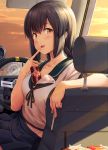  1girl between_breasts black_hair blue_skirt blush braid breasts brown_eyes car_interior car_seat cleavage collarbone eyebrows_visible_through_hair finger_to_mouth food highres ichikawa_feesu isonami_(kantai_collection) kantai_collection medium_breasts midriff open_mouth pleated_skirt pocky school_uniform serafuku short_sleeves skirt solo steering_wheel sunset twin_braids 