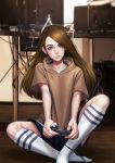  1girl black_shorts brown brown_shirt cable commentary controller game_controller green_eyes head_tilt highres holding indoors jungon_kim kneehighs long_hair looking_at_viewer no_shoes shirt short_sleeves shorts sitting white_legwear 