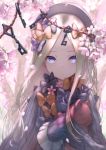  1girl abigail_williams_(fate/grand_order) bangs black_bow black_dress black_hat blonde_hair blue_eyes blurry blurry_foreground bow branch commentary_request depth_of_field dress fate/grand_order fate_(series) flower forehead hair_bow hat highres kachayori key long_hair long_sleeves looking_at_viewer object_hug orange_bow parted_bangs parted_lips pink_flower polka_dot polka_dot_bow sleeves_past_fingers sleeves_past_wrists solo stuffed_animal stuffed_toy teddy_bear very_long_hair 