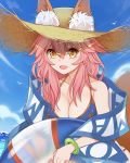  1girl animal_ears bikini blue_bikini breasts cleavage collarbone ears_through_headwear fang fate/grand_order fate_(series) fox_ears fox_tail hat heridy highres innertube large_breasts looking_at_viewer ocean open_mouth outdoors pink_hair side-tie_bikini solo straw_hat swimsuit tail tamamo_(fate)_(all) tamamo_no_mae_(swimsuit_lancer)_(fate) yellow_eyes 