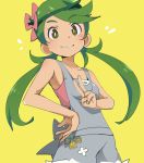  1girl apron bangs blush dark_skin eyebrows_visible_through_hair flower green_eyes green_hair hair_flower hair_ornament ixy looking_at_viewer low_twintails mallow_(pokemon) overalls pokemon pokemon_(game) pokemon_sm simple_background sleeveless smile solo swept_bangs twintails v yellow_background 