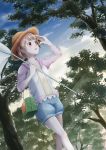  1girl blue_sky brown_eyes brown_hair butterfly_net dutch_angle forest hand_net hand_up hat highres kira_(natsu) looking_to_the_side nature original outdoors shirt shorts sky solo standing straw_hat summer tree yellow_shirt 