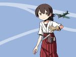  1girl adrian_ferrer aircraft airplane brown_eyes brown_hair commentary english_commentary folded_ponytail gloves hair_between_eyes hair_tie hakama_skirt kantai_collection kasuga_maru_(kantai_collection) single_glove smile solo 