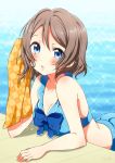  1girl bico_(bicoris) bikini blue blue_eyes breasts brown_hair cleavage highres looking_at_viewer love_live! love_live!_sunshine!! medium_breasts pool poolside swimsuit towel watanabe_you wet 