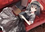  1girl arm_up bangs black_dress black_hair blush book closed_mouth collared_dress commentary_request couch dress eyebrows_visible_through_hair hair_between_eyes highres kinona long_hair lying on_back on_couch open_book original short_hair solo violet_eyes 