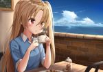  1girl ame. azur_lane bangs blue_shirt blue_sky blush brick_wall chair cleveland_(azur_lane) clouds collared_shirt commentary_request cup day eyebrows_visible_through_hair hair_between_eyes holding holding_cup horizon indoors light_brown_hair long_hair looking_away ocean one_side_up parted_lips polo_shirt red_eyes shirt short_sleeves sitting sky solo table very_long_hair water 